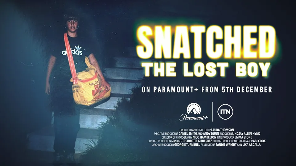 Programme title card for "Snatched: The Lost Boy", showing a teenage boy carrying a newspaper delivery bag down outdoor steps at night.